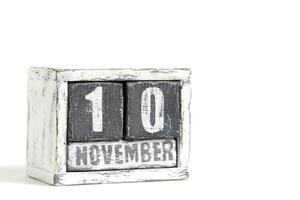 November 10 on wooden calendar, on white background. photo
