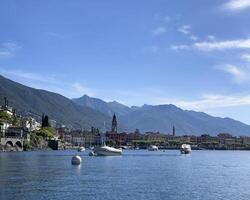 boats are docked in the water near a mountain range photo