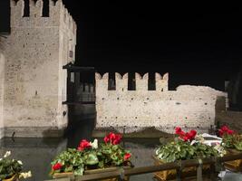 a castle with a moat and a wall photo