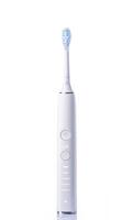 a white electric toothbrush with a green toothbrush head photo