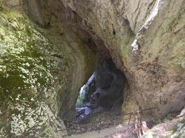 a cave with a small opening at the top photo