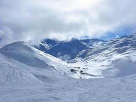 a snowy mountain with a ski slope photo