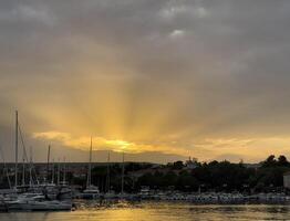 a boat is docked at a marina at sunset photo