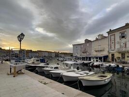 a row of boats docked at a marina photo