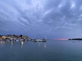 a view of boats in the water at dusk photo