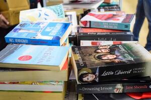 New Delhi, India, September 09 2023 - Variety of Books on shelf inside a book-stall at Delhi International Book Fair, Selection of books on display in Annual Book Fair. photo