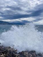 waves crashing on the rocks at the coast photo