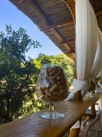 a view of a balcony with a glass of wine and a table with a glass of wine photo