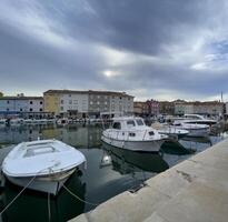 boats docked in the harbor of the old town of rovinj, croatia photo