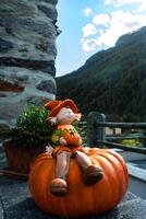 a statue of a girl sitting on a pumpkin photo