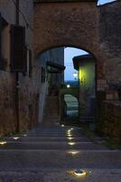 a street with steps lit up at night photo