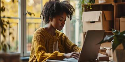 AI generated A young dark-skinned business woman surrounded by boxes, working on a laptop. Small business, delivery, businesswoman. Proud business owner. Bokeh effect. AI generated. photo