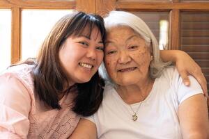 Portrait of asian senior mother and adult daughter photo