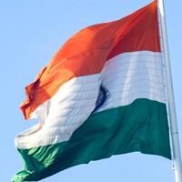 India flag flying high at Connaught Place with pride in blue sky, India flag fluttering, Indian Flag on Independence Day and Republic Day of India, tilt up shot, Waving Indian flag, Har Ghar Tiranga photo