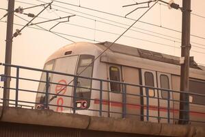 New Delhi India - October 09 2023 - Delhi Metro train arriving at Jhandewalan metro station in New Delhi, India, Asia, Public Metro departing from Jhandewalan station photo