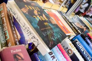 New Delhi, India, September 09 2023 - Variety of Books on shelf inside a book-stall at Delhi International Book Fair, Selection of books on display in Annual Book Fair. photo