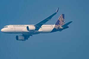 New Delhi, India, December 25 2023 - Vistara Airbus A320 neo take off from Indra Gandhi International Airport Delhi, Vistara domestic aeroplane flying in the blue sky during day time photo