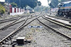 View of train Railway Tracks from the middle during daytime at Kathgodam railway station in India, Toy train track view, Indian Railway junction, Heavy industry photo