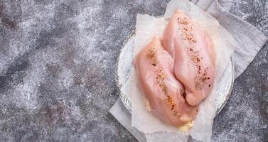 Raw chicken fillet on cutting board photo