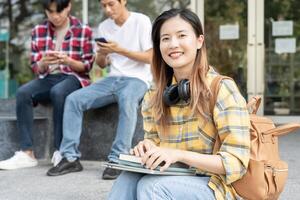 Portrait beautiful Asian woman student. Smile girl happy study. read book in college campus. young female on international Asia University. Education, study, school, learning, exam, continue education photo