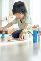 Happy Asian child playing and learning toy blocks. children are very happy and excited at home. child have a great time playing, activities, development, attention deficit hyperactivity disorder photo