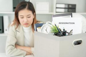 resignation, leave, quit, Stressful businesswomen will resign from the company. Female staff is lifting a brown paper box that holds personal items. , job placement and vacancies, resignation letter photo