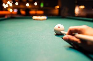 Man preparing to break spheres in billiard photo