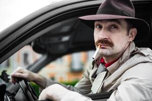 Detective smoking a cigarette in his car while stalking photo