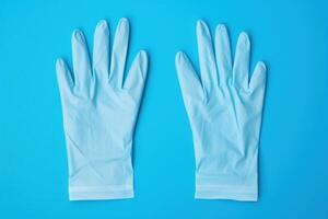 AI generated Protective Pair of medical gloves on blue background. Generate Ai photo