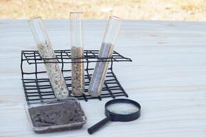 Test tubes that contain sample soil. Concept, soil quality inspection, research and science experiment. Laboratory. Find the best from different soil type and source for growing agriculture crops photo