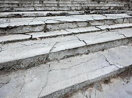 a stone staircase with cracks on the steps photo