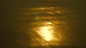 Abstract blur light on sea and ocean, clear water, Water surface with light reflections and gentle waves, Serene water with a sun reflection, Reflection of sunset light on the water surface, sparkling video