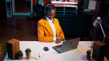 African american girl listening to professor debating latest lesson, taking notes after understanding explanations. Student participating at online school classes on academic platform. Camera B. video