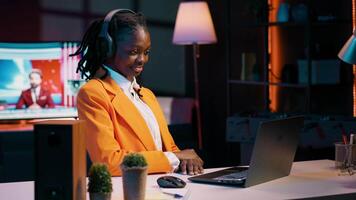 African american girl listening to professor debating latest lesson, taking notes after understanding explanations. Student participating at online school classes on academic platform. Camera A. video