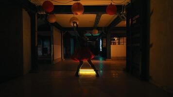 Silhouette of a person dancing under lanterns at night video