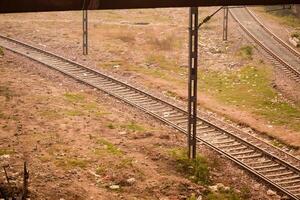 View of train Railway Tracks from the middle during daytime at Kathgodam railway station in India, Toy train track view, Indian Railway junction, Heavy industry photo