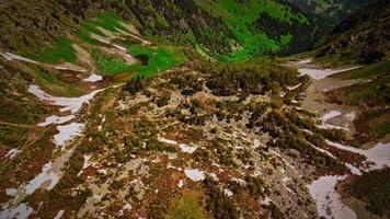 Drone flies over green mountain forests during sunlight, landscape. tourist attractions, mountain lake in the Caucasus video