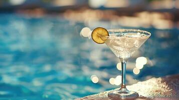 AI generated cocktail on the pool deck, its crystal-clear glass shimmering in the sunlight against a backdrop of tranquil blue waters, evoking a sense of luxury and relaxation. photo