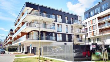 Modern apartment buildings on a sunny day with a blue sky. Facade of a modern apartment building. Glass surface with sunlight. photo