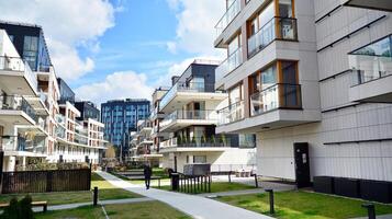 Modern apartment buildings on a sunny day with a blue sky. Facade of a modern apartment building. Glass surface with sunlight. photo