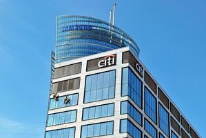 Glass building with transparent facade of the building and blue sky. Structural glass wall reflecting blue sky. Abstract modern architecture fragment. Contemporary architectural background. photo