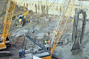 High rise building under construction. Installation of glass facade panels on a reinforced concrete structure. photo