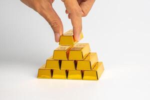 Financial wealth, investment and trading concept.gold bars or gold ingot stacking with business hand. photo