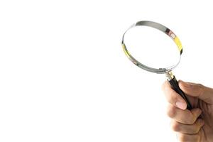 Hand holding magnifier tool isolated on white background. discover and research concept. photo