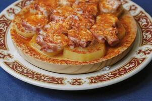 Galician wing octopus served on a plate photo