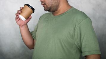 Green T-shirt men drink paper cup hot photo