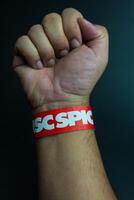 Bangkok, Thailand - February 14, 2024 A red of wristband from spicydisc. The spicydisc is is a music label in Thailand and famous. photo