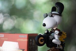 BANGKOK, THAILAND - FEBRUARY 21, 2024 A toy of Snoopy, Motorcycle energy, cute toy from pop mart the Best Friends series figures photo