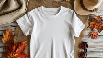 AI generated a white t-shirt mockup with a blank shirt template photo, featuring stylish fall accessories against a rustic burlap background for a trendy and seasonal aesthetic. photo