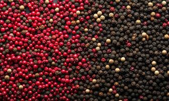 AI generated Red, black, white and pink peppercorns on black background photo